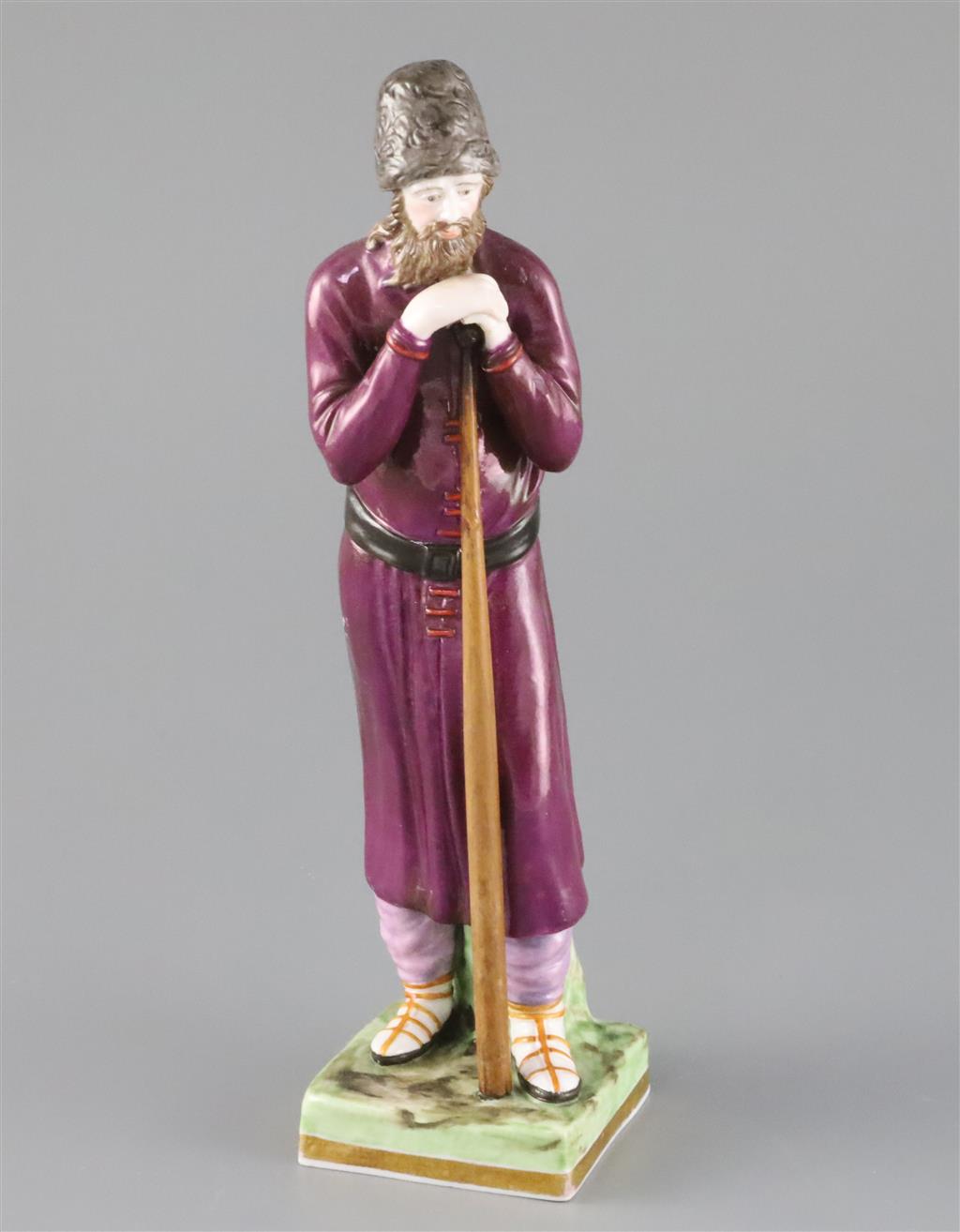 A Russian Gardner porcelain figure of a man holding a staff, mid 19th century, H.21.4cm, loss to left hand and replacement staff